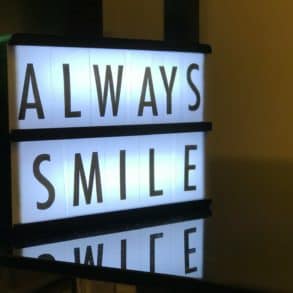 back lit sign saying 'always smile'