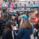 Young people milling around the theatrecraft marketplace event