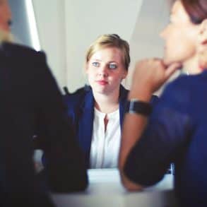 three women sat at a table talking