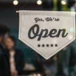 A 'yes we are open' sign on a shop door