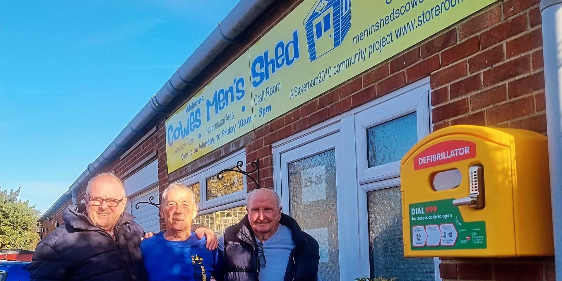 Members of Cowes Men's Shed outside with the newly installed defibrilator