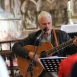 Man playing the guitar at All Saint's Church in Ryde