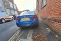 Car parked on the pavement blocking access with wheelchair