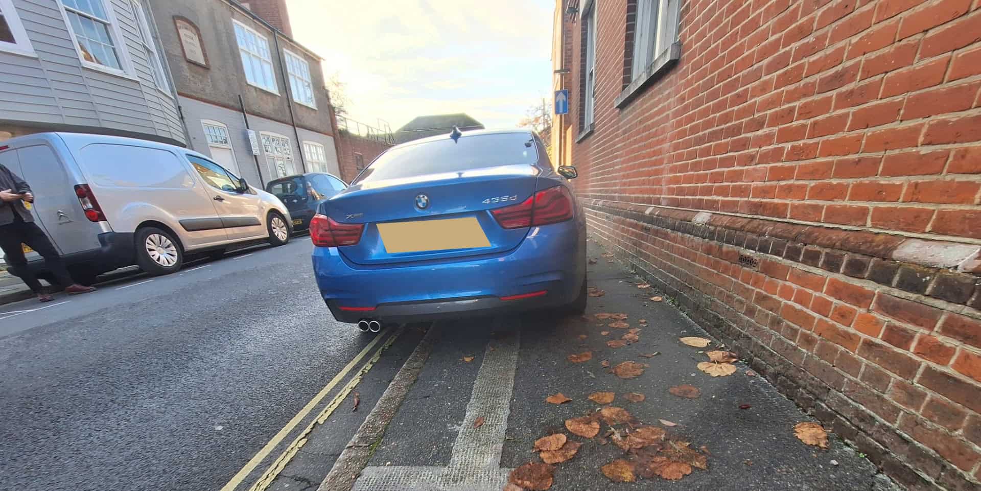 Car parked on the pavement blocking access with wheelchair