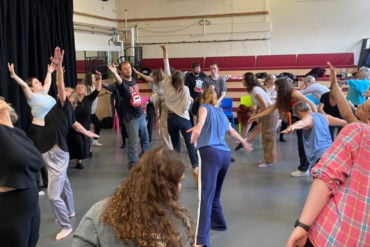 Community dance class with people of all ages dancing