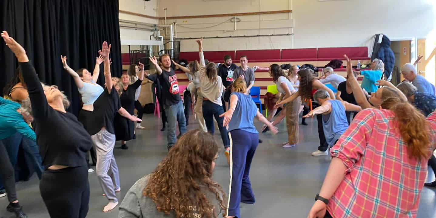 Community dance class with people of all ages dancing