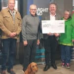 Representative of IW Pony Club, Cat, a nursery nurse from the neonatal unit, Graeme Burnett from Ventnor Cricket Club, representative of Ventnor Youth FC, Jon Carter, WightAID donor from Betapak, reps from Ventnor Carnival Association, and WightAID founder Geoff Underwood. Front is Mavis, the WightAID dog.