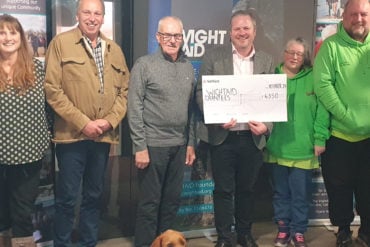 Representative of IW Pony Club, Cat, a nursery nurse from the neonatal unit, Graeme Burnett from Ventnor Cricket Club, representative of Ventnor Youth FC, Jon Carter, WightAID donor from Betapak, reps from Ventnor Carnival Association, and WightAID founder Geoff Underwood. Front is Mavis, the WightAID dog.