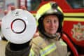 Firefighter holding a Smoke Alarm