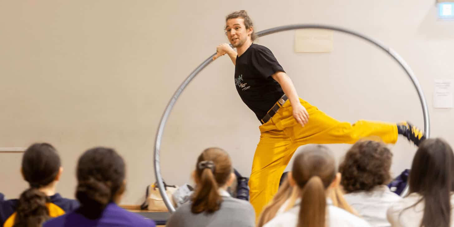 Thorn on the acrobat's wheel showing pupils his skills