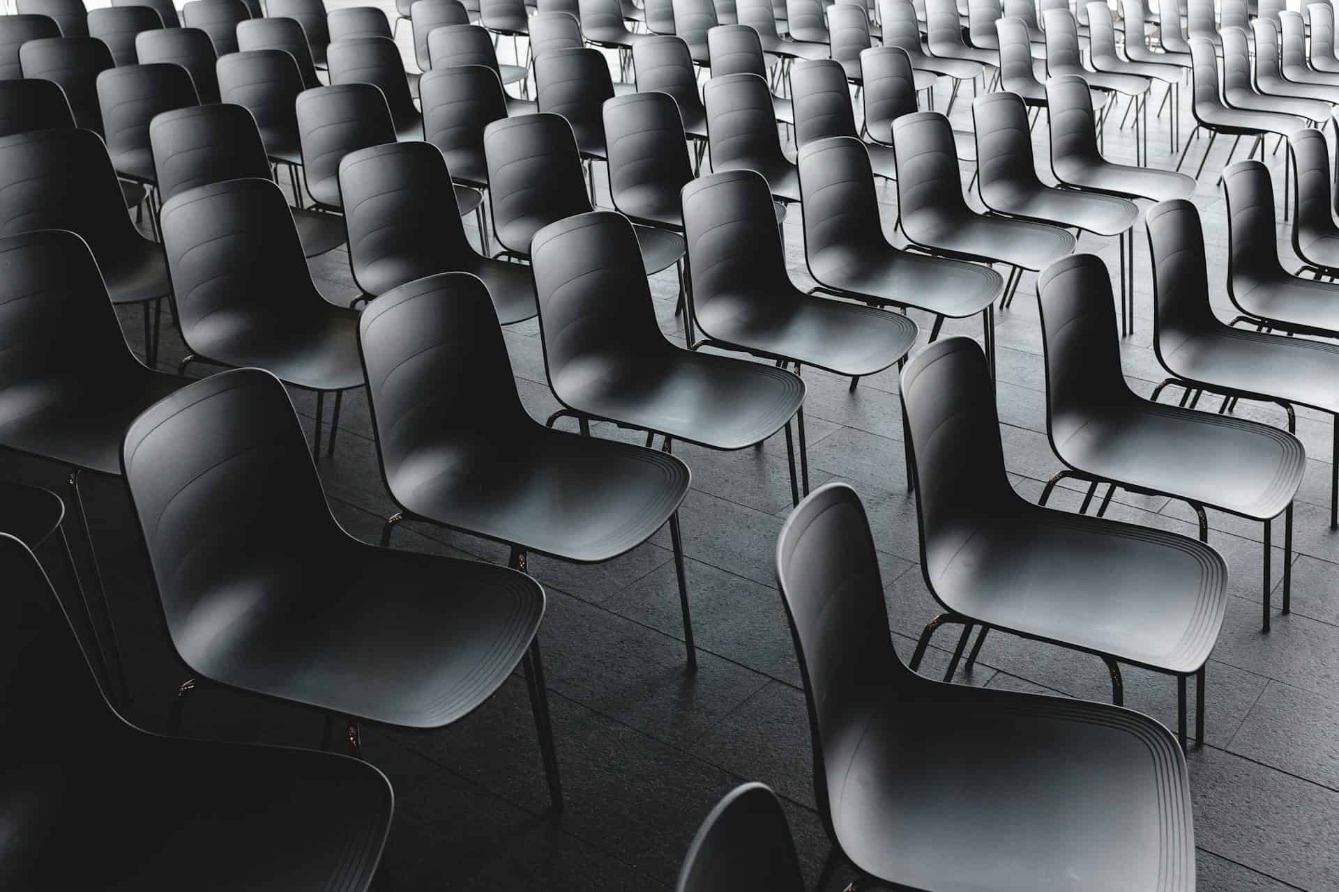 a room full of empty black chairs