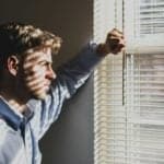 depressed man looking out of the window