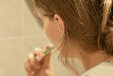 person brushing their teeth