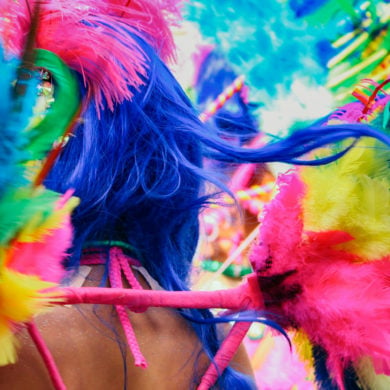 A woman dressed in extravagant carnival outfits