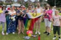 CEC with rainbow flag at start of carnival parade