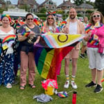 CEC with rainbow flag at start of carnival parade