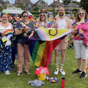 CEC with rainbow flag at start of carnival parade