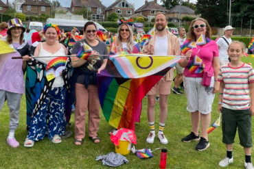 CEC with rainbow flag at start of carnival parade