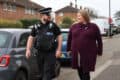 Donna Jones walking down the street with a local bobby police officer