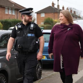 Donna Jones walking down the street with a local bobby police officer