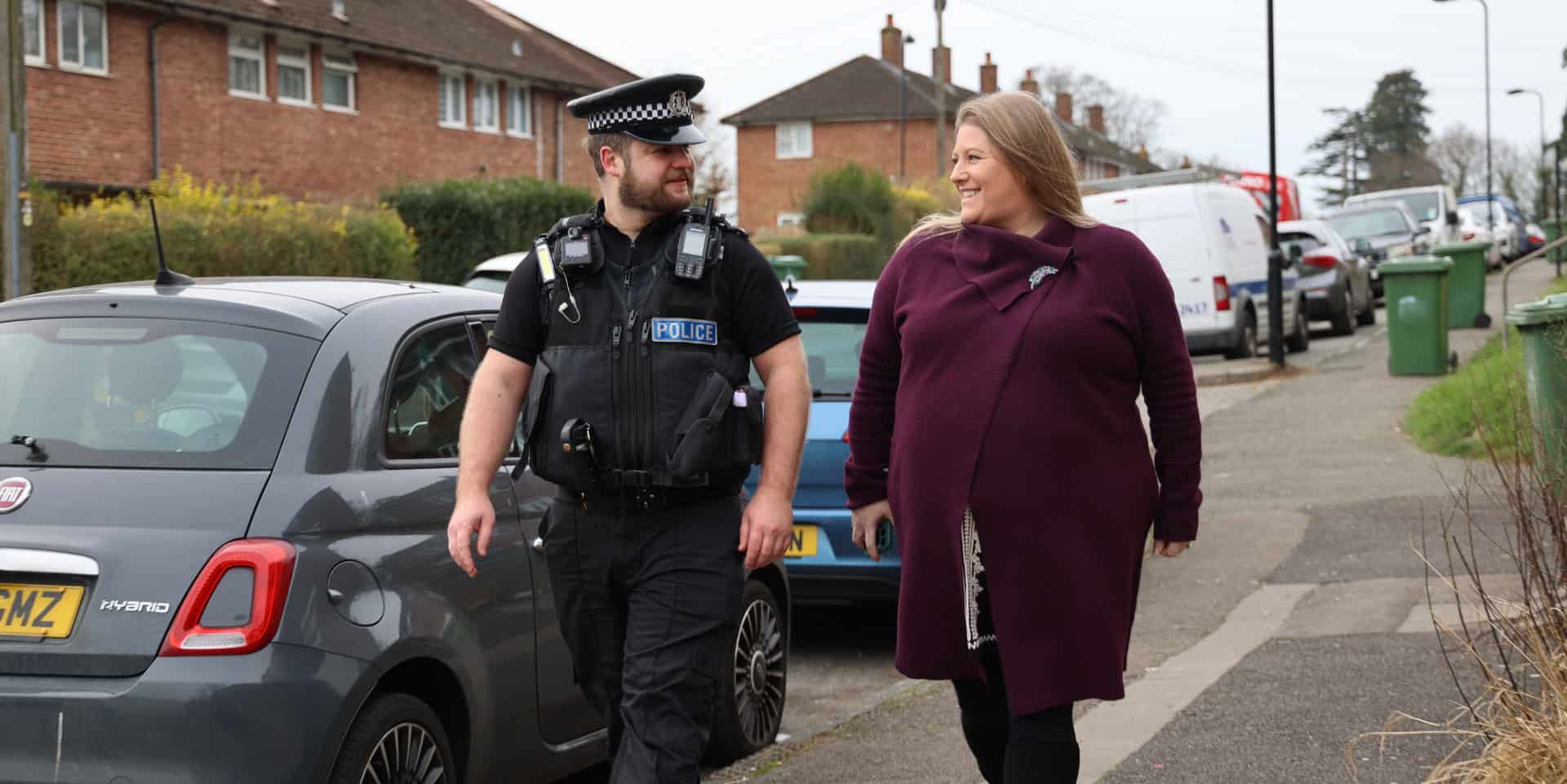 Donna Jones walking down the street with a local bobby police officer