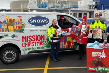 Wightlink staff Michelle Leonard, Jermaine Knight (at the wheel) Riley Chilton and Sophie Green join Samantha Tanner (dressed in red) to load gifts into the Mission Christmas van