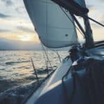 a yacht sailing into the sunset