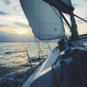 a yacht sailing into the sunset