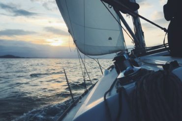 a yacht sailing into the sunset