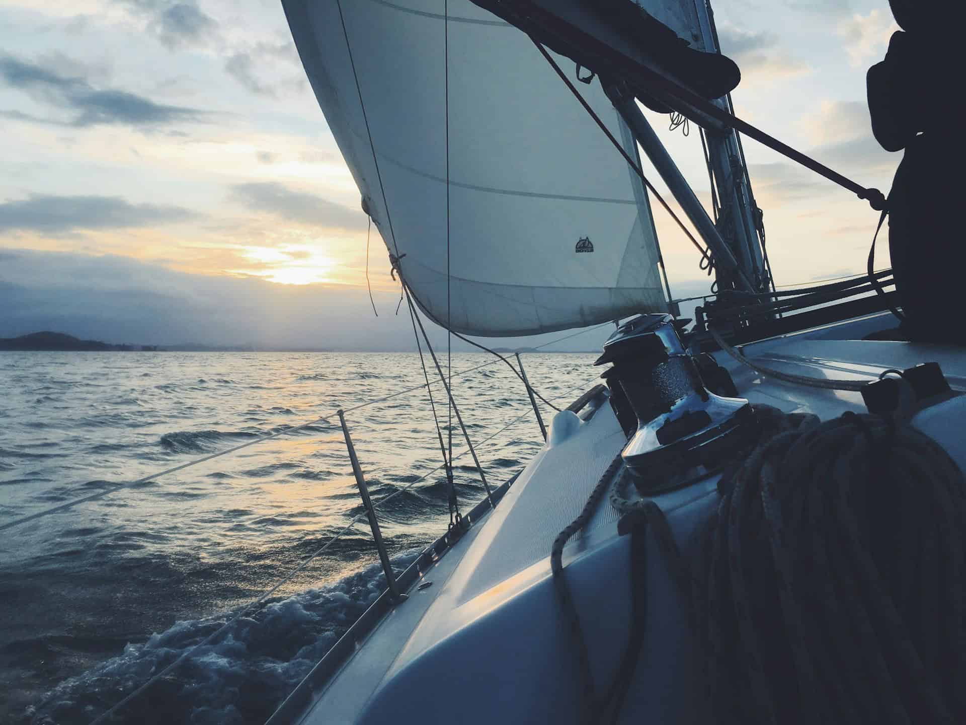 a yacht sailing into the sunset