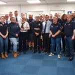 RNLI Station Volunteers and family pose with HM Lord-Lieutenant