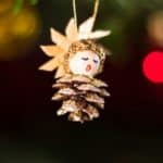 pine cone carol singer hanging off christmas tree