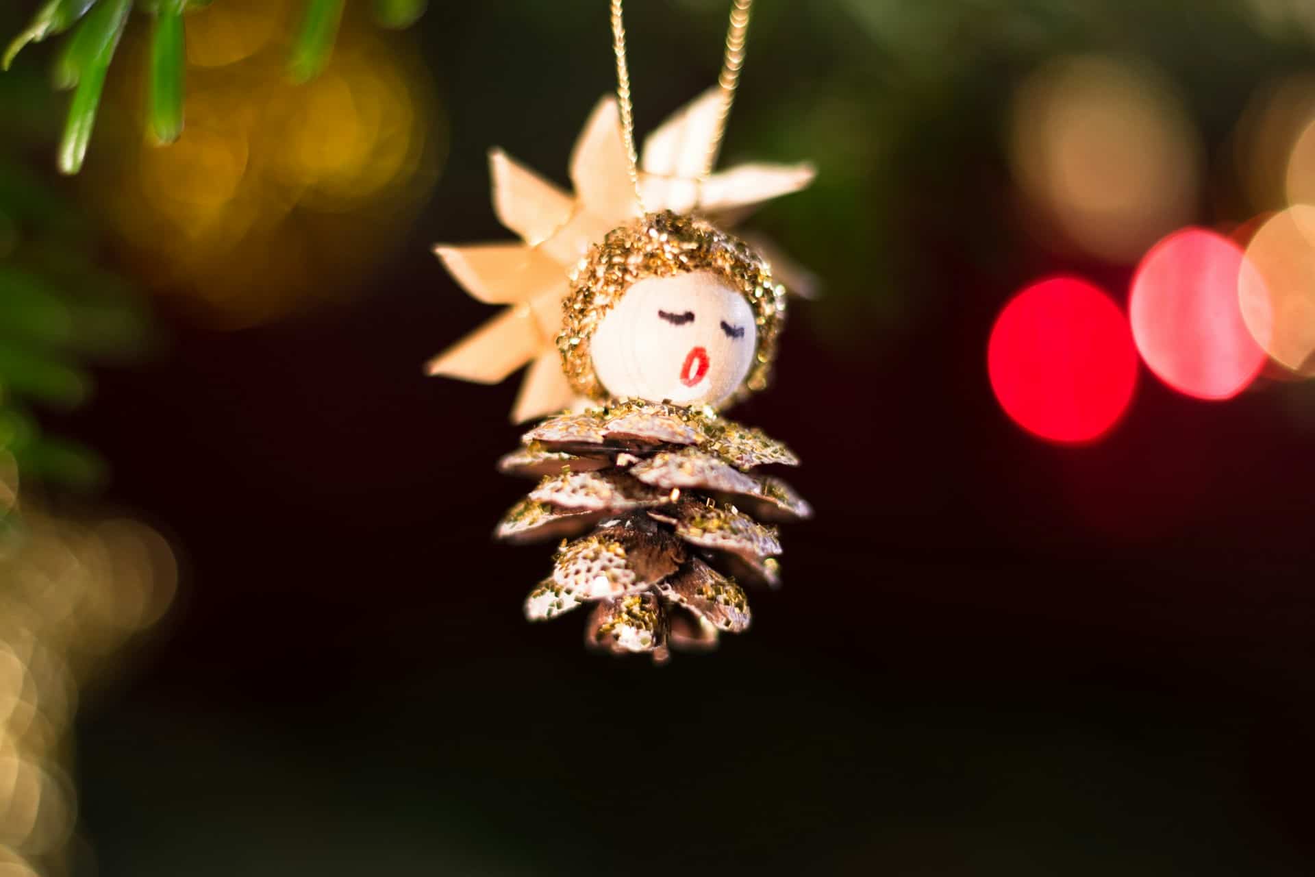 pine cone carol singer hanging off christmas tree