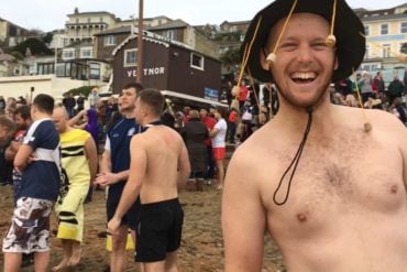 Bare topped man taking part in boxing day swim