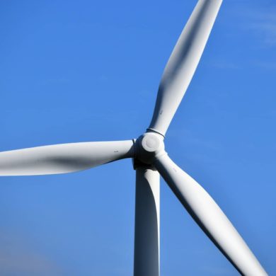 wind turbine blades against a blue sky