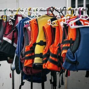 A rail of lifejackets and buoyancy aids