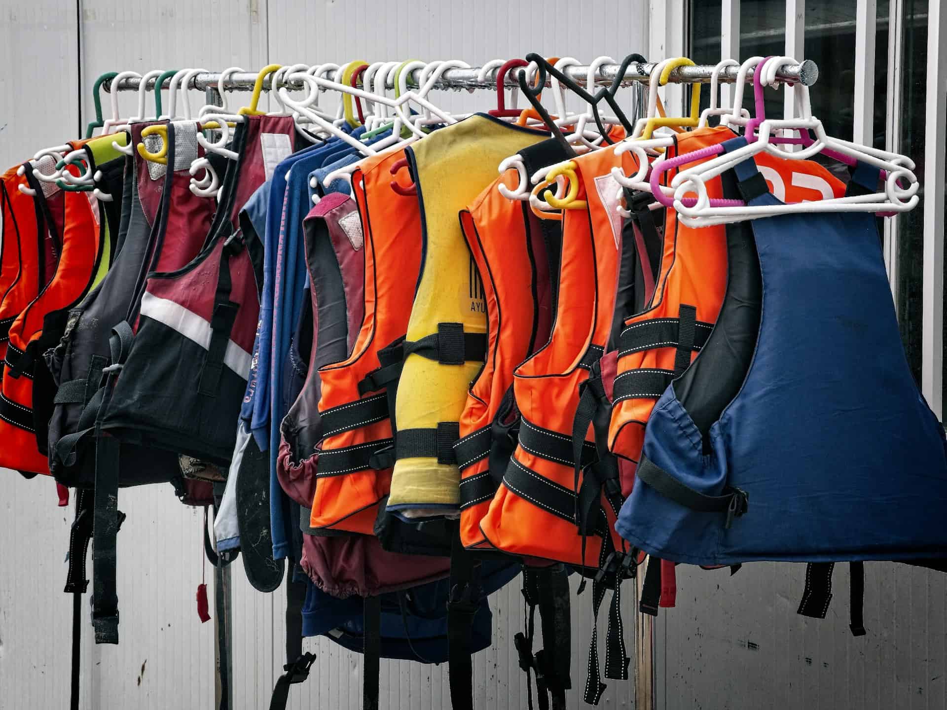 A rail of lifejackets and buoyancy aids