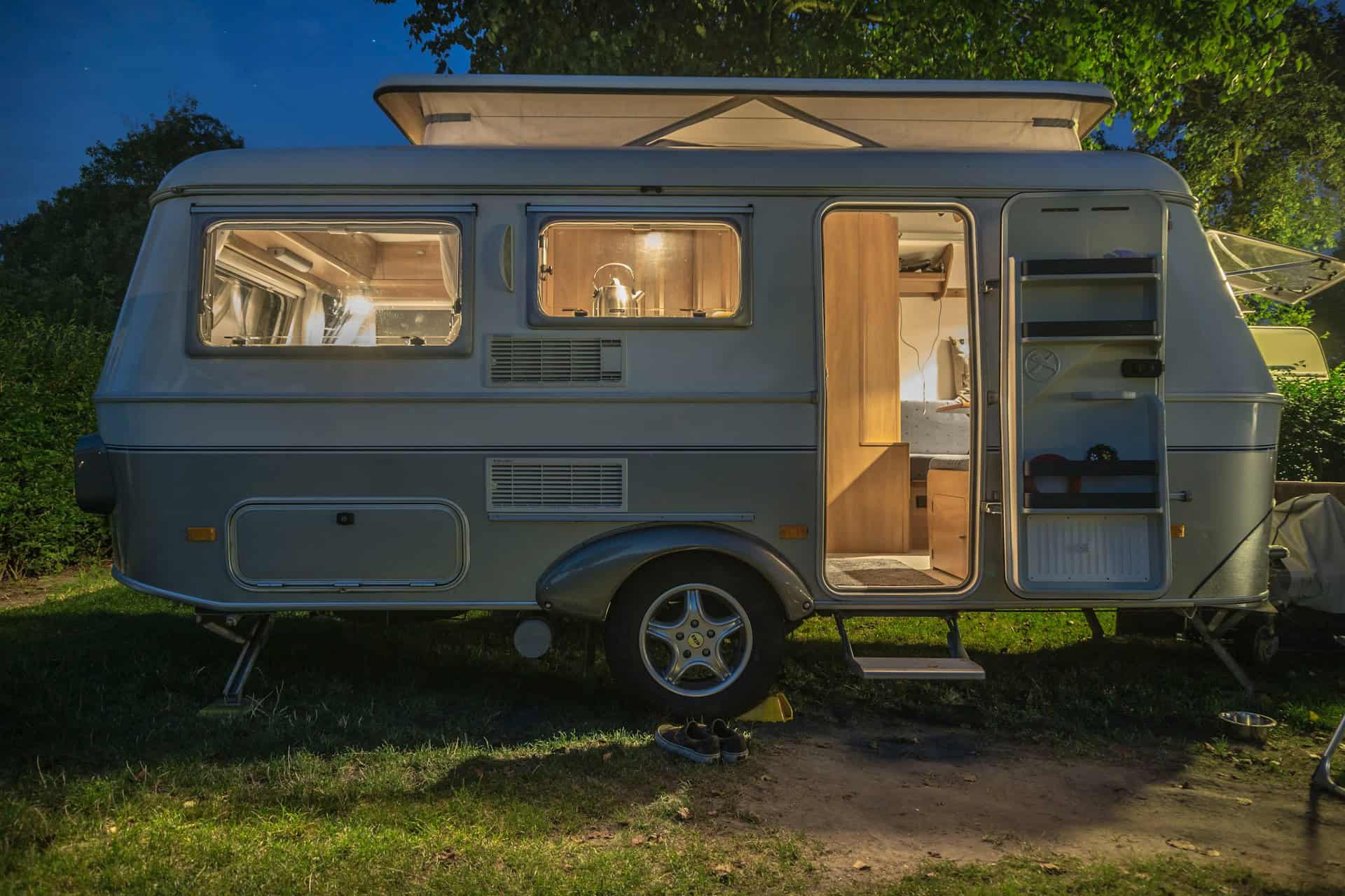 Caravan with lights on and door open