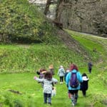 children at carisbrooke castle exploring the ladnscape