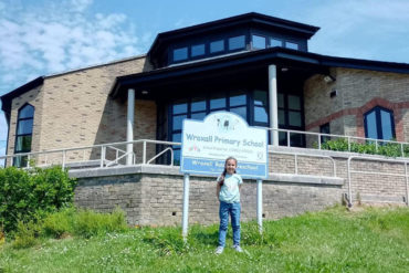 Ellie outside the school