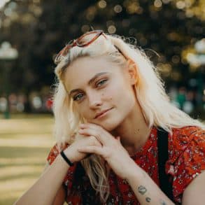 Female teenager sitting in park by bailey burton