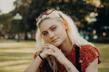 Female teenager sitting in park by bailey burton