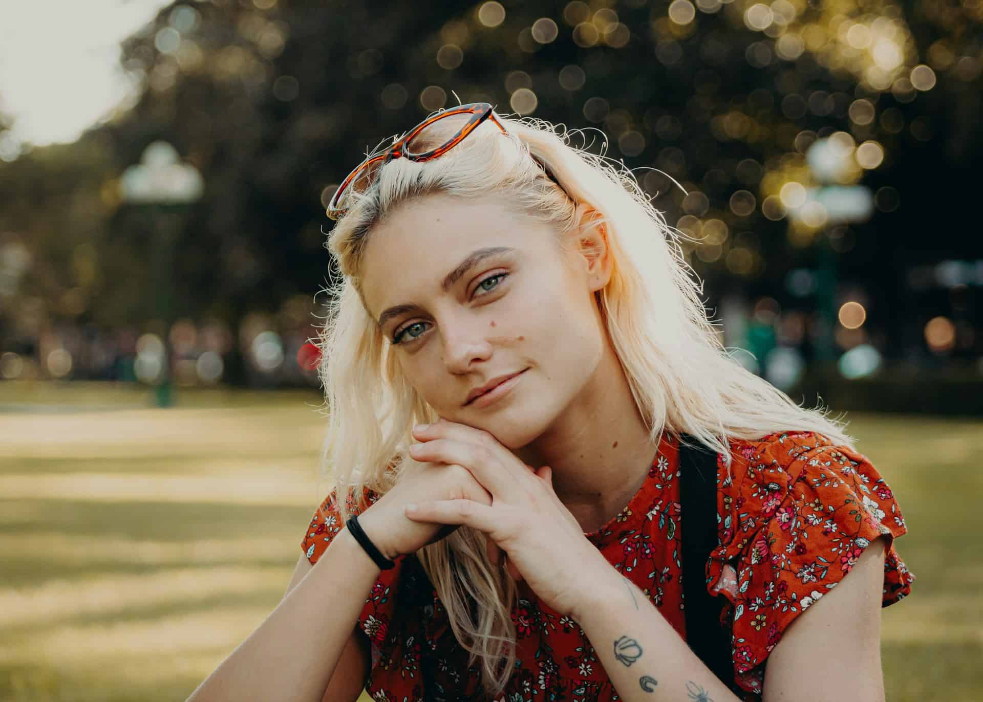 Female teenager sitting in park by bailey burton