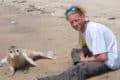 Jason Nicholls on the beach with a seal