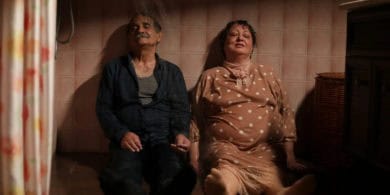 Scene from 'My Favourtie cake' showing two older characters with their feet up