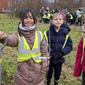 Children planting trees in Pan Community Park