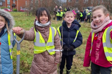 Children planting trees in Pan Community Park