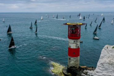 Aerial shot of round the island race boats going around the Needles