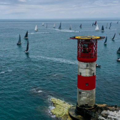 Aerial shot of round the island race boats going around the Needles