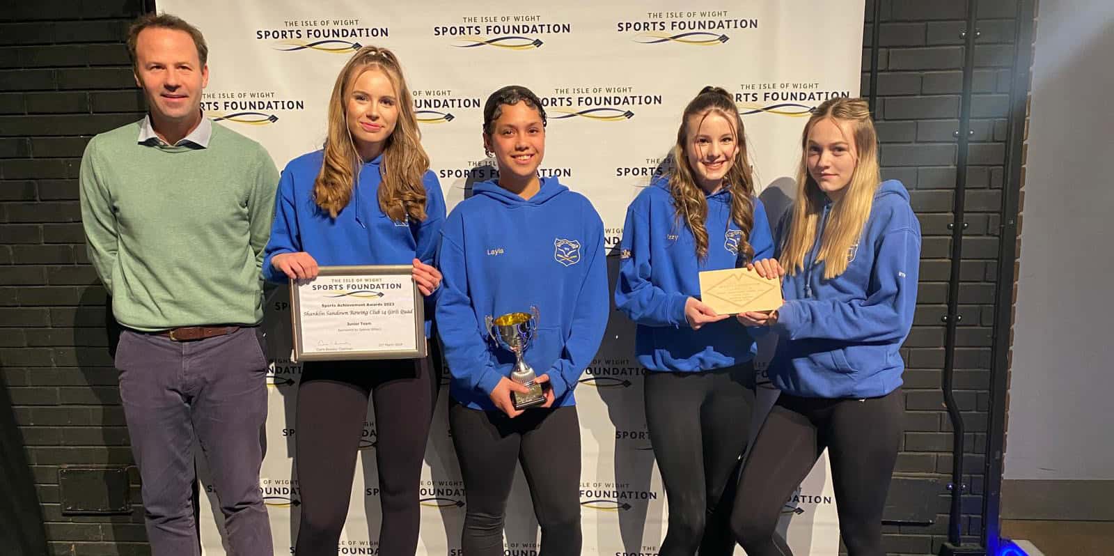 Young sporting stars with their awards